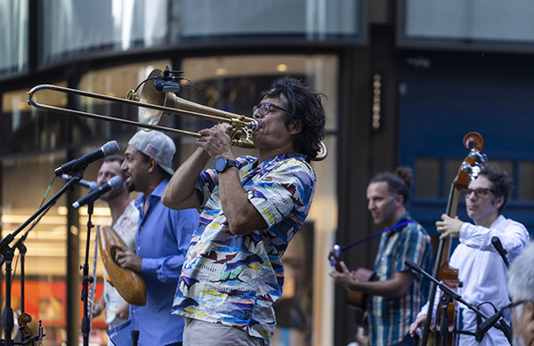 Man Playing Trombone with a band
