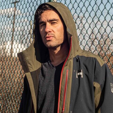 Dan Fireberg in front of chain link fence