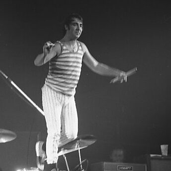 Keith Moon standing on drum kit